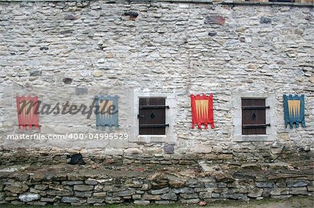 Knightly flags on ancient walls of a castle Haapsalu