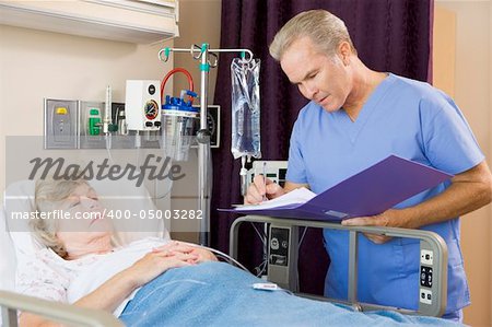 Doctor Making Notes About Patient