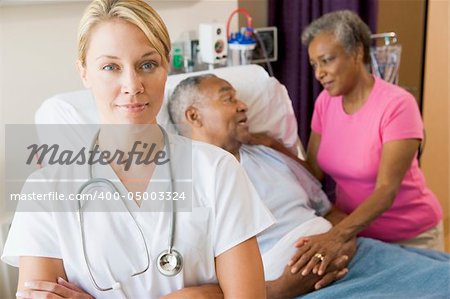 Doctor Standing In Hospital Room With Her Arms Folded