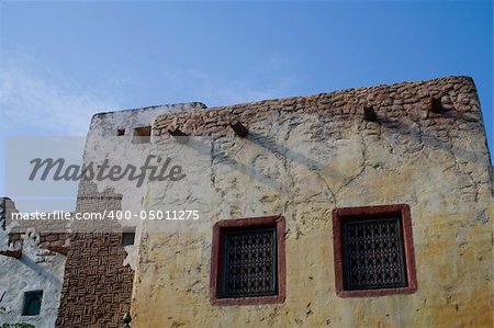 a perspective of a mexican house and a blue sky