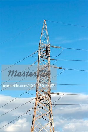 electric pillar and cables in blue cloudy sky
