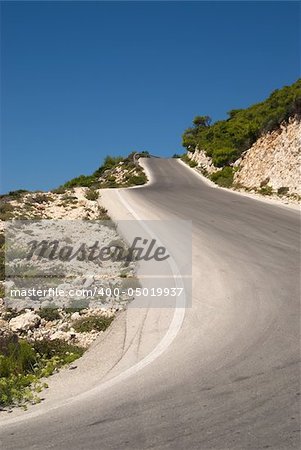 Curvy and narrow one lane road on a mountain