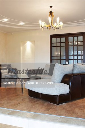 Sofa, armchair and coffee table in the modern house