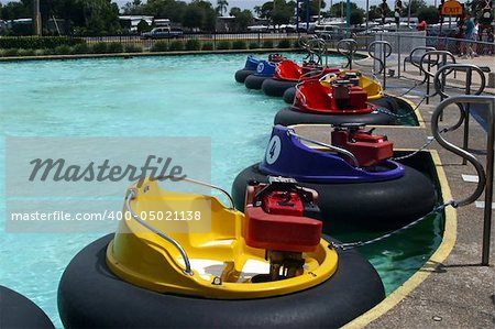 A row of bumper boats at an amusement park.