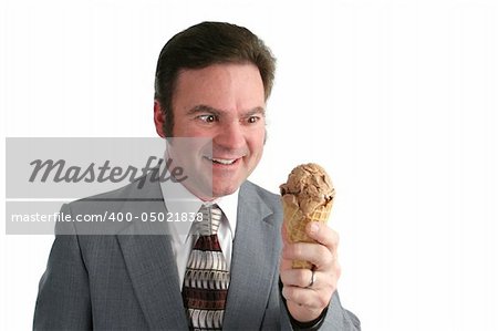 A businessman looking at an ice cream cone with a crazed look.