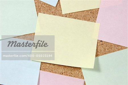 Close up of colorful post-it notes on corkboard