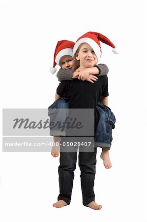 Two adorable brothers with Christmas hats. On white background.