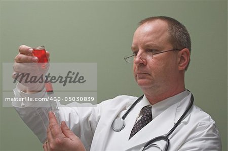 A medical doctor preparing an injection in a syringe.