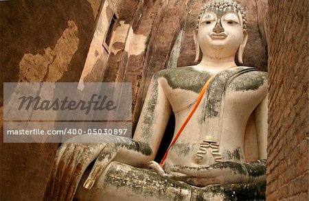 huge seated buddha in the ancient city of sukothai in thailand