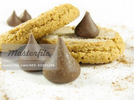 Peanut butter cookies with chocolate kisses on a plate with cinnamon.