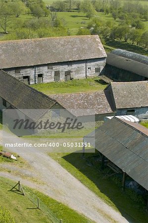 Farm buildings and farmhouse in countryside.