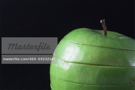 A sliced green apple in a stack.