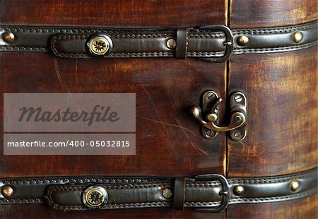 Old wooden suitcase with leather belts