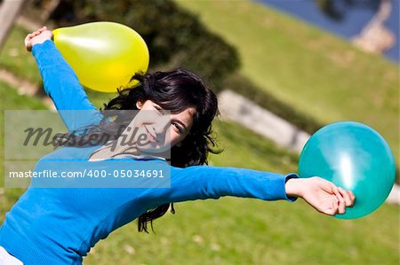 Beautiful teen handling balloons