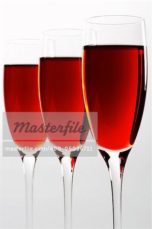 Three high and beautiful glasses with red wine