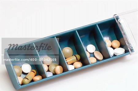 Pill boxes indicating days of the day with pills  on bright Background