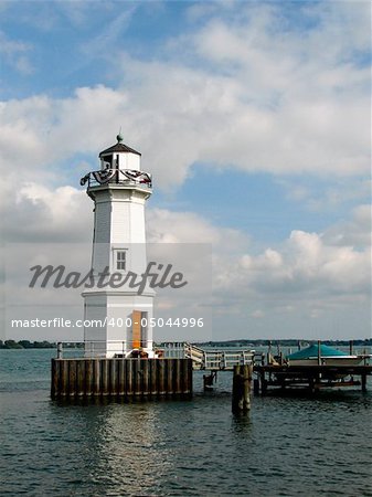 Boat moored by a lighthouse in the water