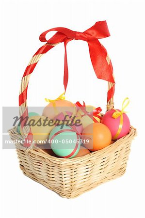 Colored easter eggs in basket, isolated on white background