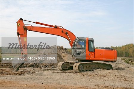 Photo of a working excavator in the countryside