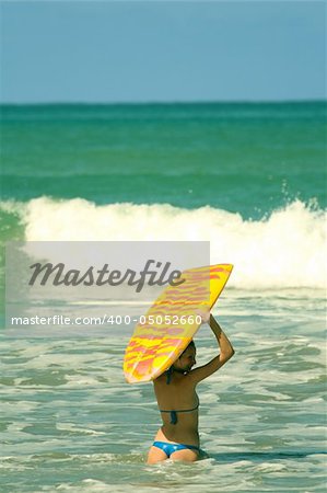 Bikini Girl with boogie board in the water