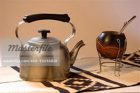 An Argentinean Yerba Mate scene, including a kettle on a typical South American rug.