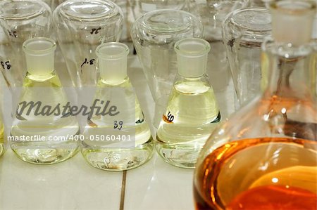 Many different flasks with liquid in chemistry lab