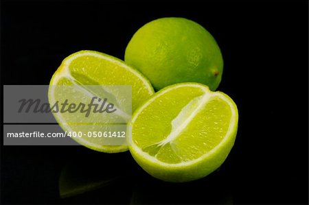 Lemon and lime citrus fruit isolated against a black background