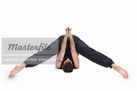 Young male gymnast practicing yoga.
