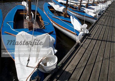 Many blue sailing boats in the marina