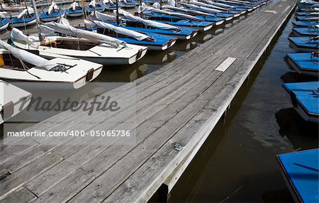 Many blue sailing boats in the marina