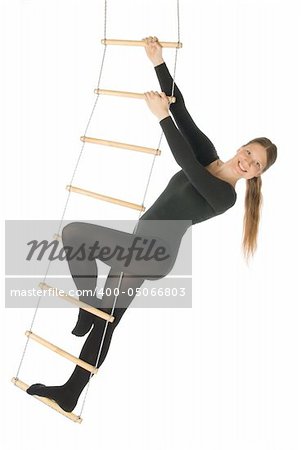An isolated photo of a woman on a rope ladder