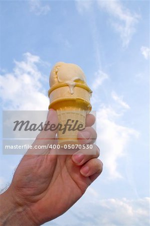A delicious vanilla ice cream cone on a hot day.