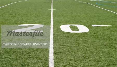 Green football field with large yard numbers.