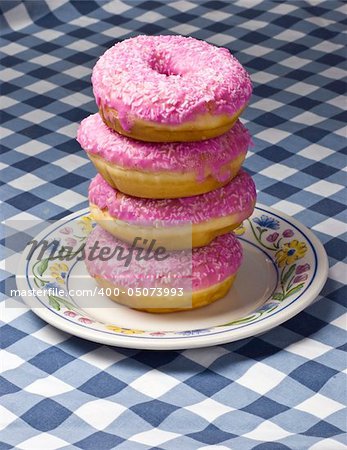 plate of pink donuts