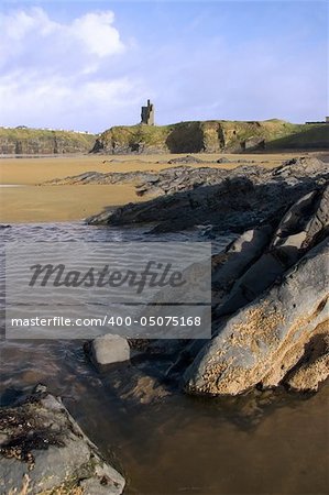 a rocky beach on a warm day with a calm sea an ideal place to have a walk in ireland