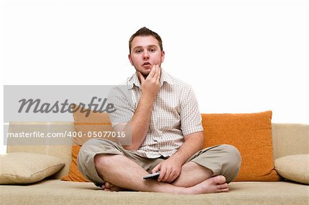 casual man watching tv on sofa