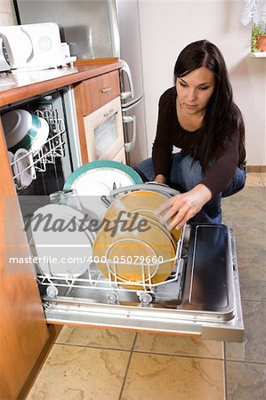 attractive brunette woman cleaning kitchen