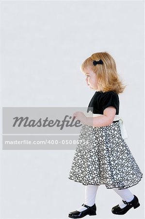 Beautiful Little Girl Walking in a Formal Dress