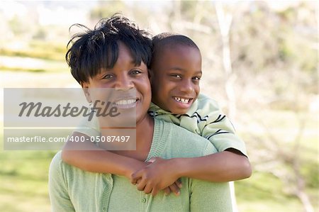 Happy Woman and Child having fun in the park.