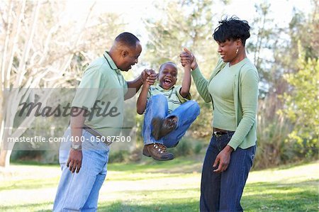 Man, Woman and Child having fun in the park.