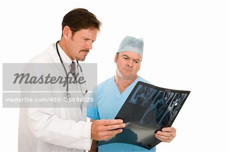 Radiologist and surgeon worried over MRI test results.  Isolated on white.