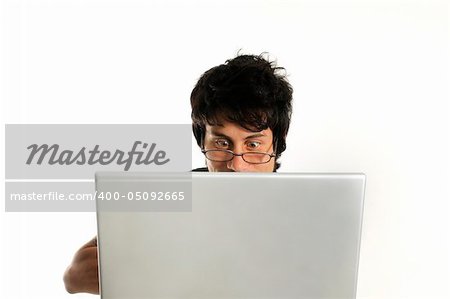 Portrait of young man with eyegalsses using laptop isolated