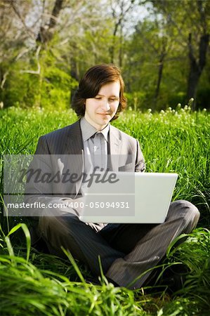 man with laptop on the grass