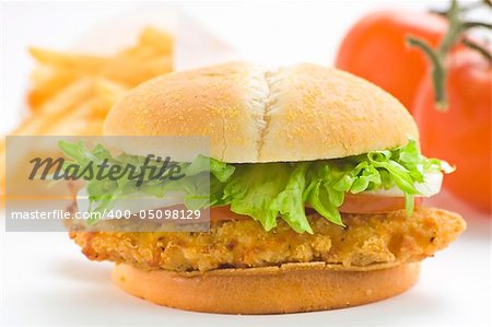 crisp chicken burger with tomato onion cheese lettuce isolated