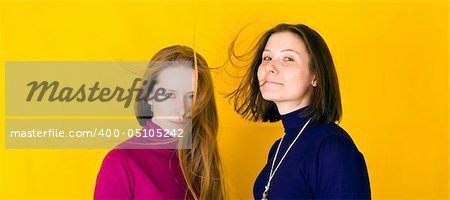 Close-up portrait of beautiful girl. Isolated over yellow background