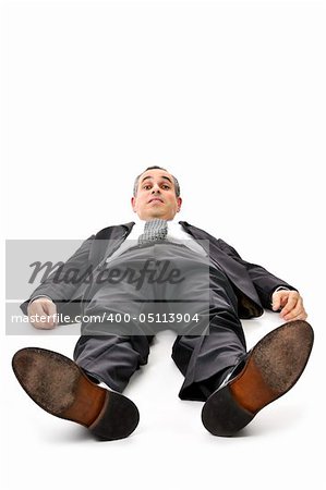 Scared businessman laying down in a suit isolated on white background