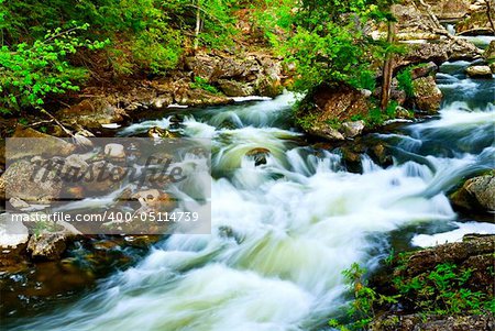 Water rushing among rocks in river rapids in Ontario Canada