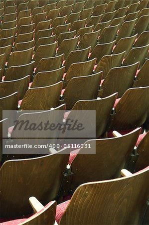 empty wooden cinema or theatre seats, vertical photo