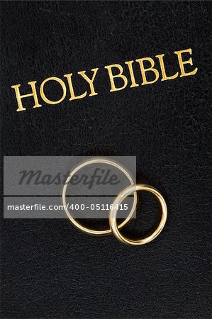 Gold Wedding Rings on the Worn Cover of a Bible