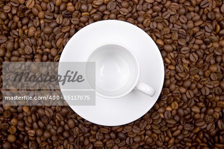 white cup over coffee bean made background. landscape orientation.